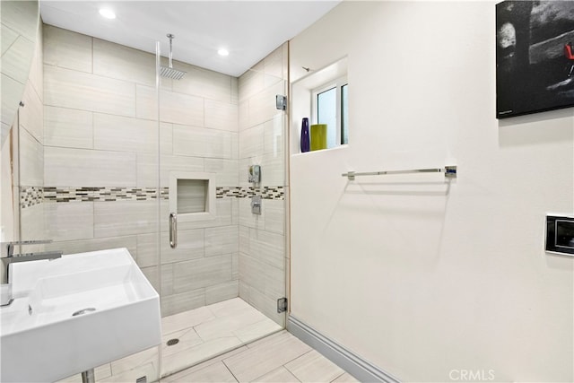 bathroom featuring sink and an enclosed shower