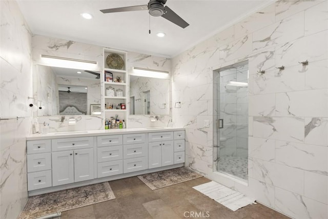 bathroom featuring vanity, a shower with door, crown molding, ceiling fan, and tile walls