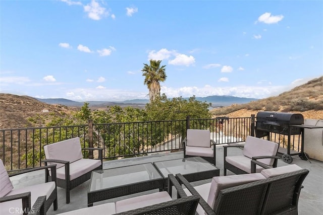 exterior space featuring outdoor lounge area, a mountain view, and a grill