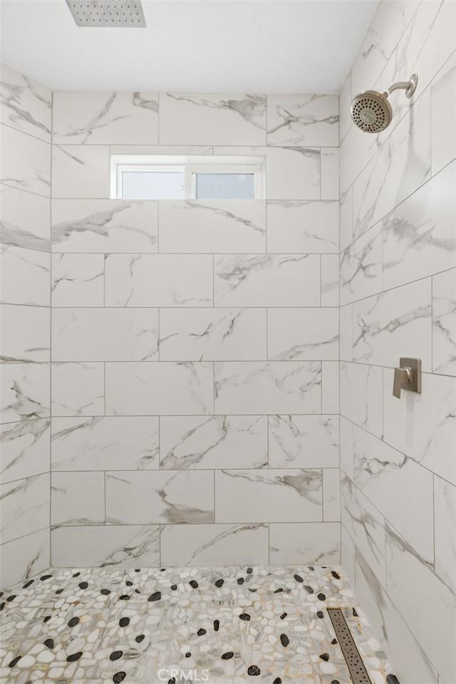 bathroom with a tile shower