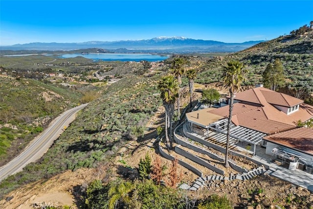 drone / aerial view featuring a water and mountain view