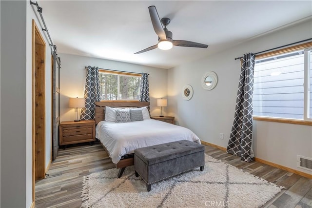 bedroom featuring hardwood / wood-style flooring and ceiling fan