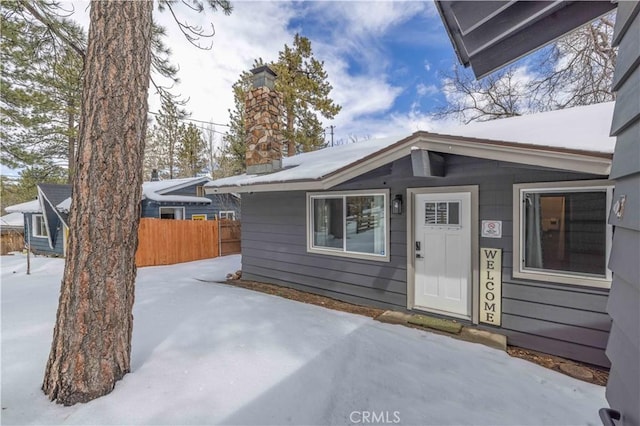 view of snow covered property entrance