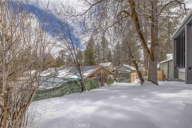 view of yard layered in snow