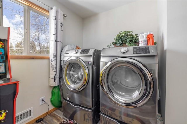 washroom featuring washer and clothes dryer and hardwood / wood-style floors