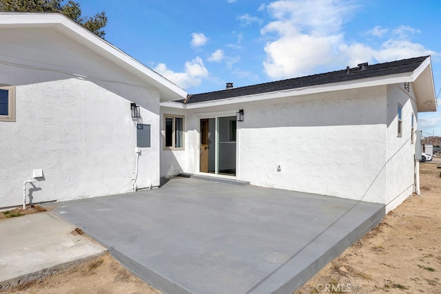 back of property with a patio