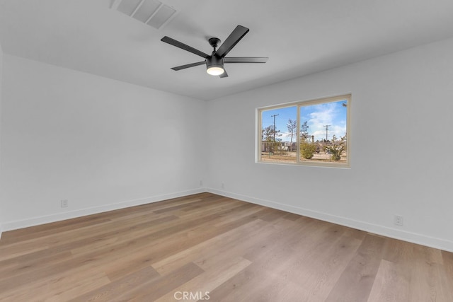 spare room with light hardwood / wood-style floors and ceiling fan