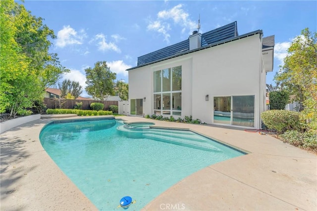 view of pool with an in ground hot tub and a patio area