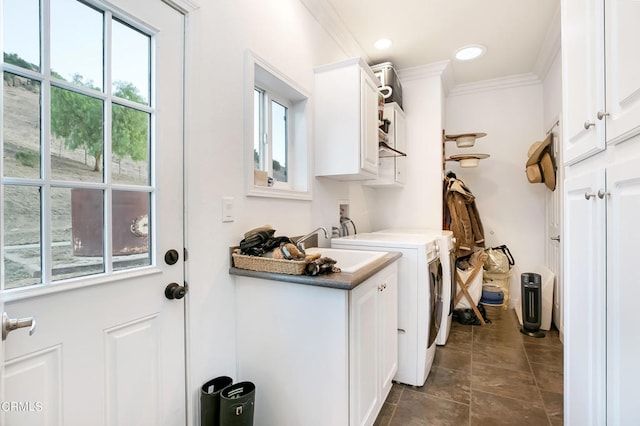 clothes washing area featuring cabinets, crown molding, independent washer and dryer, and a wealth of natural light