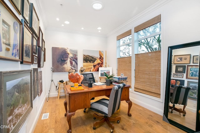 office space featuring crown molding and light hardwood / wood-style flooring