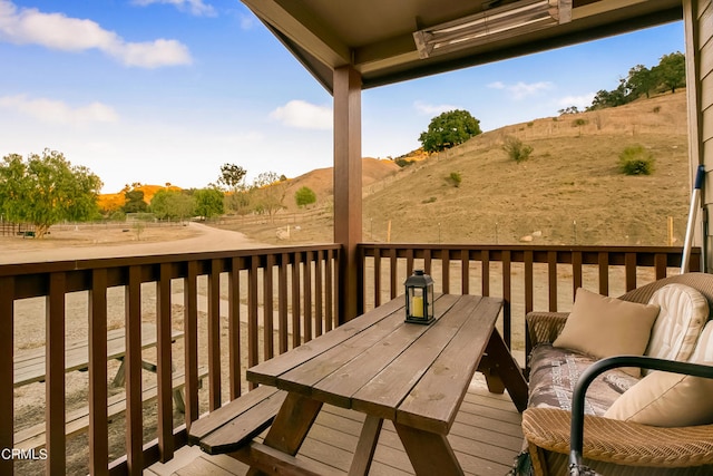 wooden deck featuring a rural view