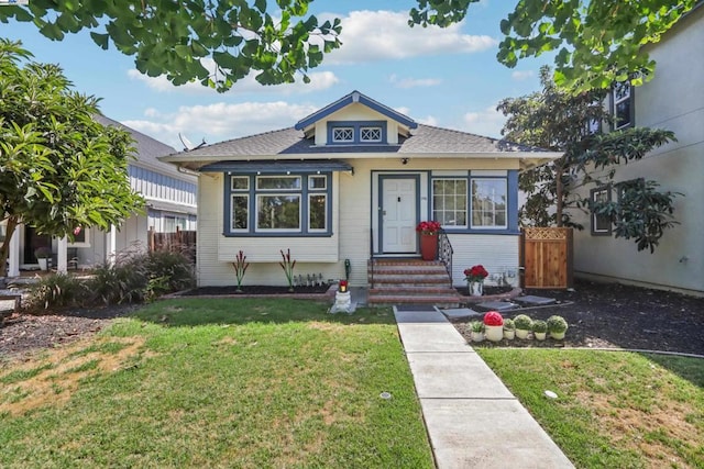 bungalow-style home with a front lawn