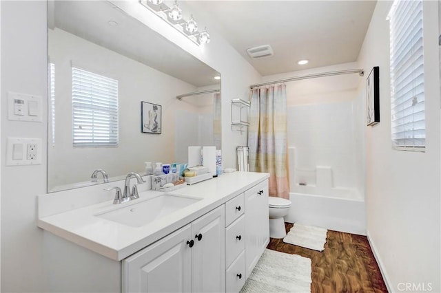 full bathroom with wood-type flooring, vanity, toilet, and shower / bathtub combination with curtain