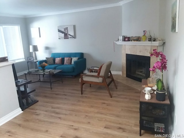 living room featuring a premium fireplace, crown molding, and wood-type flooring