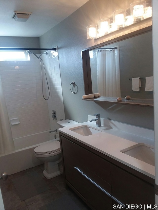 full bathroom with vanity, shower / bath combo with shower curtain, toilet, and tile patterned flooring