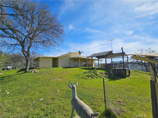 view of front of property featuring a front lawn and a gazebo