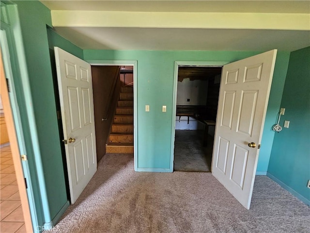 unfurnished bedroom featuring carpet flooring and baseboards