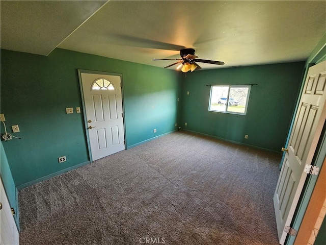 entrance foyer with carpet floors, ceiling fan, and baseboards