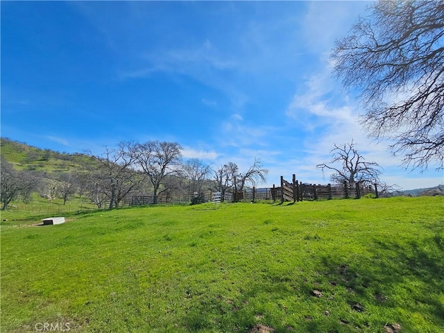 view of yard featuring a rural view and fence