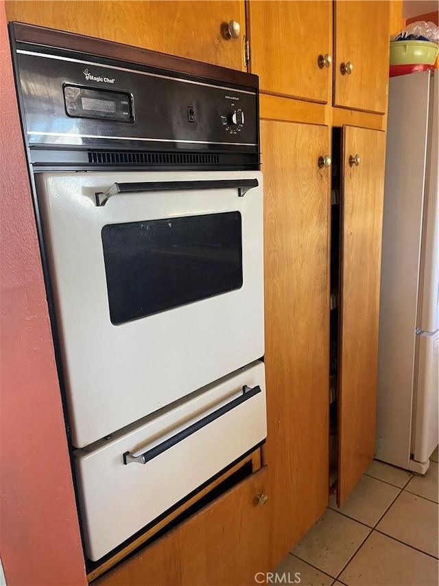 room details with refrigerator and white double oven