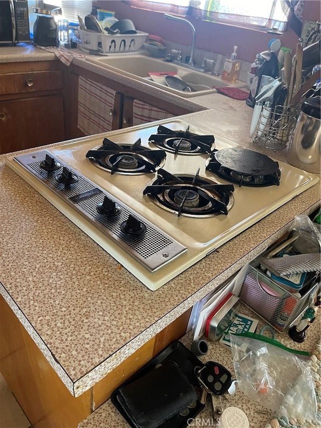 details featuring white gas cooktop and sink