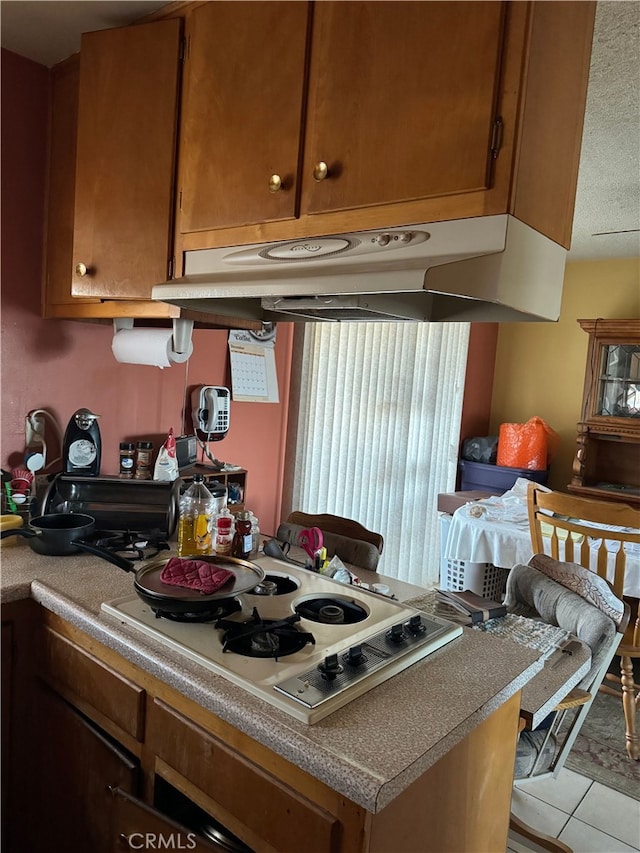 kitchen featuring white gas stovetop and light tile patterned floors