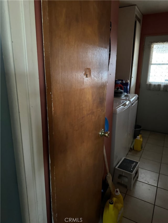 laundry room featuring separate washer and dryer and light tile patterned floors