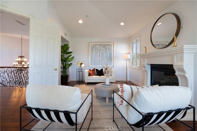 living room with light wood-type flooring and a notable chandelier