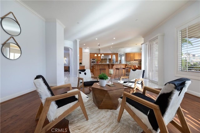 living room featuring ornamental molding and light hardwood / wood-style flooring