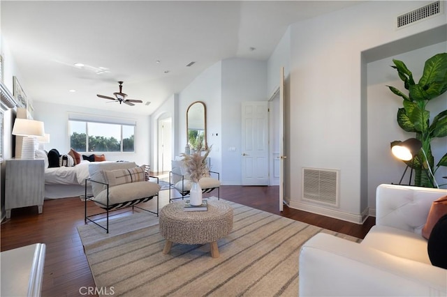 living room featuring dark wood-type flooring, ceiling fan, and lofted ceiling