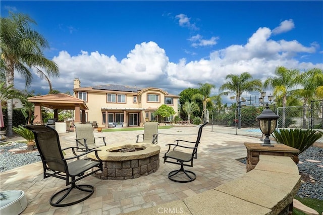 view of patio / terrace featuring a gazebo and a fire pit