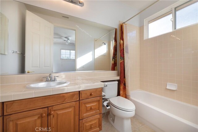 full bathroom with toilet, ceiling fan, tile patterned flooring, shower / tub combo, and vanity