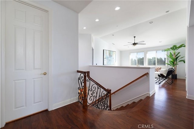 hall featuring dark wood-type flooring and lofted ceiling