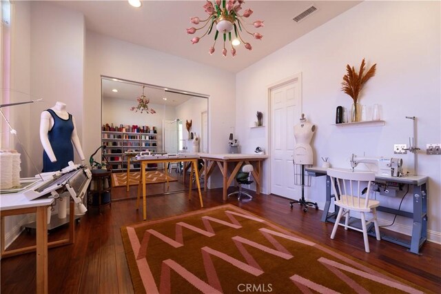 office area featuring an inviting chandelier and dark hardwood / wood-style floors