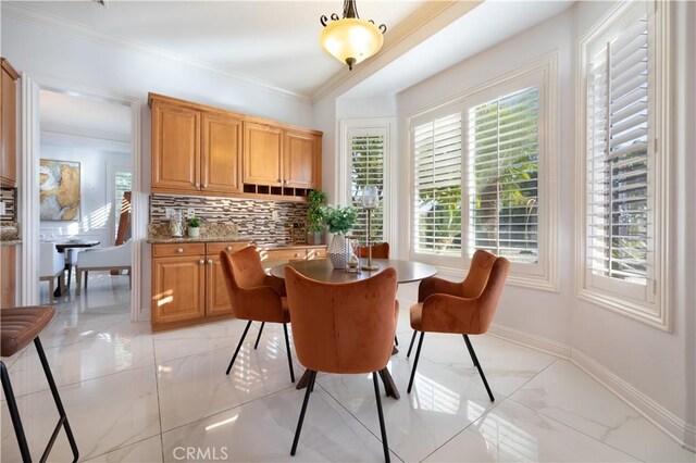 dining space with ornamental molding