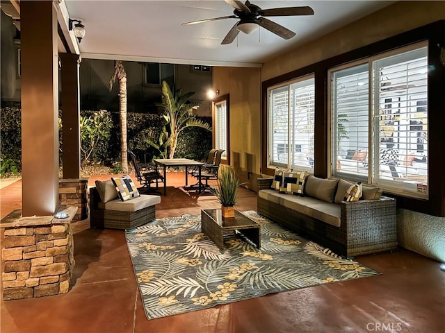 interior space featuring ceiling fan and concrete floors