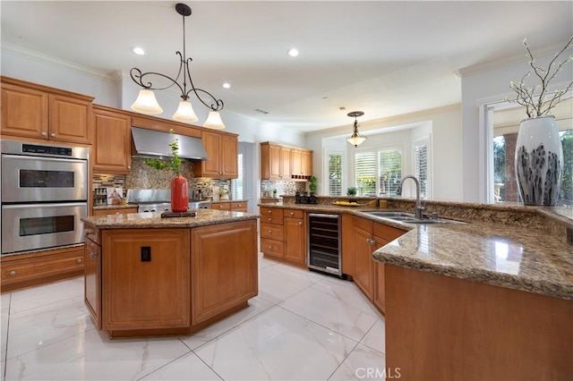 kitchen featuring a kitchen island, pendant lighting, wine cooler, and wall chimney range hood