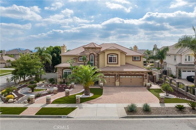 mediterranean / spanish-style home with a garage