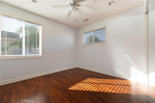 unfurnished room with ceiling fan and dark hardwood / wood-style floors