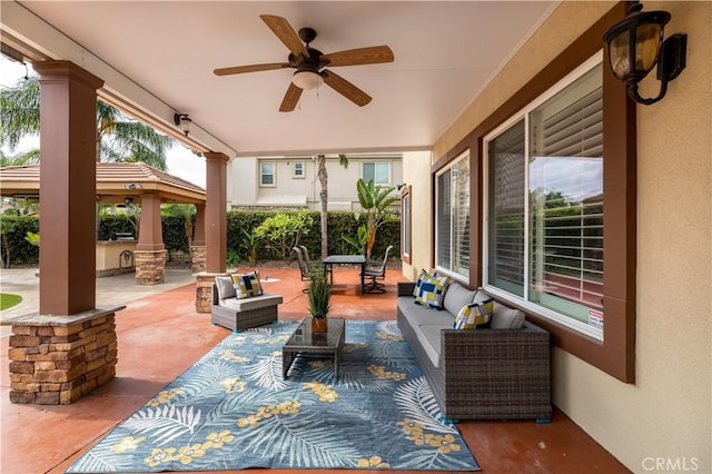 view of patio with ceiling fan, a gazebo, and an outdoor living space