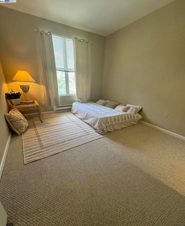 bedroom featuring baseboard heating and carpet flooring