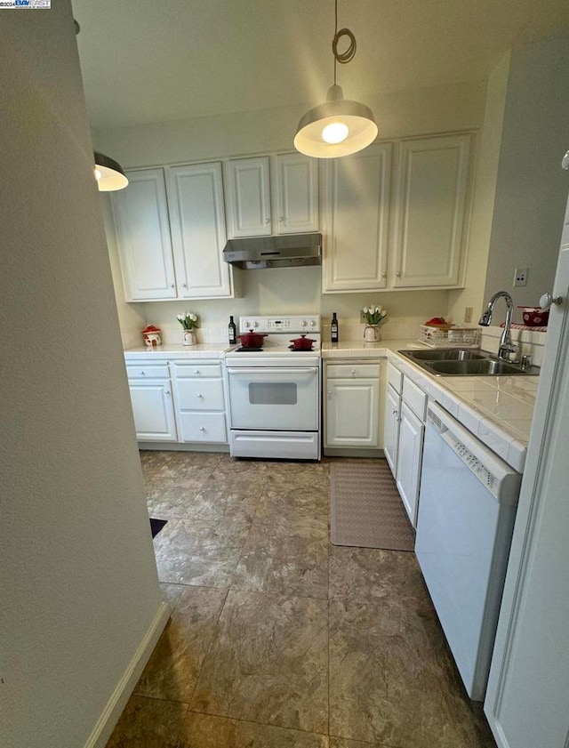 kitchen featuring white appliances, sink, decorative light fixtures, and white cabinets