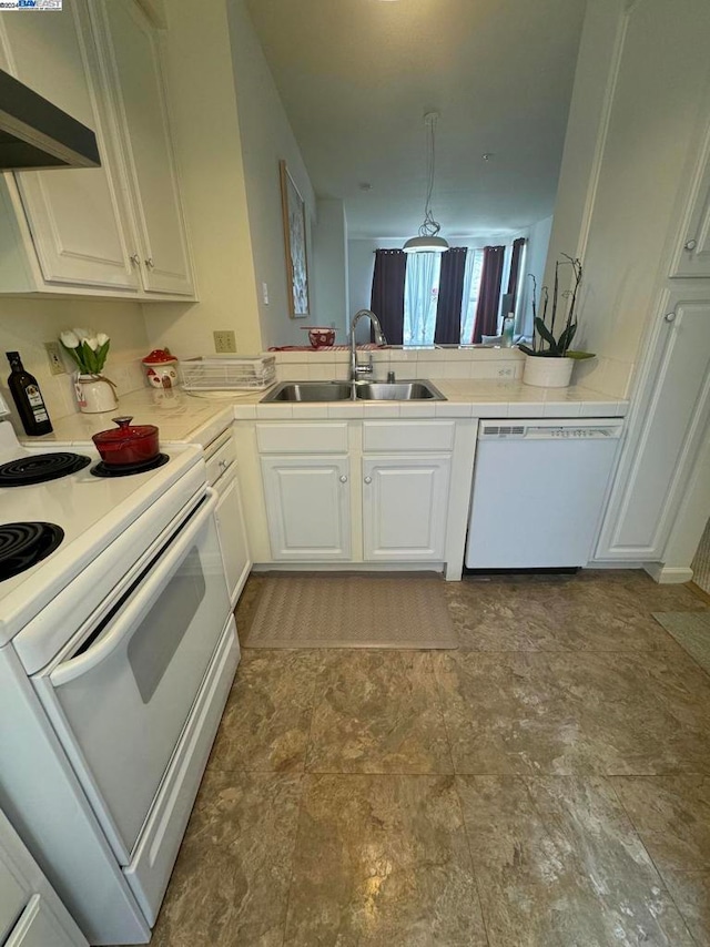 kitchen with white appliances, sink, white cabinetry, pendant lighting, and ventilation hood