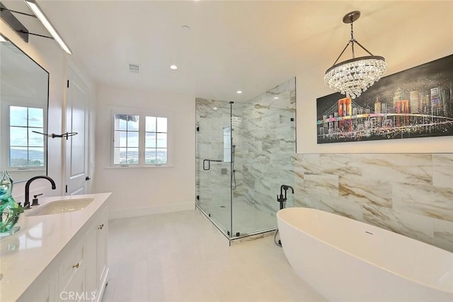 bathroom featuring a chandelier, shower with separate bathtub, and vanity