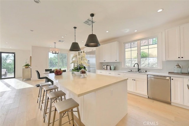 kitchen featuring dishwasher, a wealth of natural light, and sink