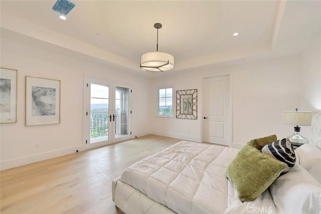 bedroom featuring light hardwood / wood-style floors, access to exterior, and french doors