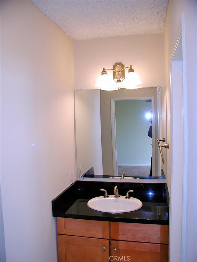 bathroom with vanity and a textured ceiling