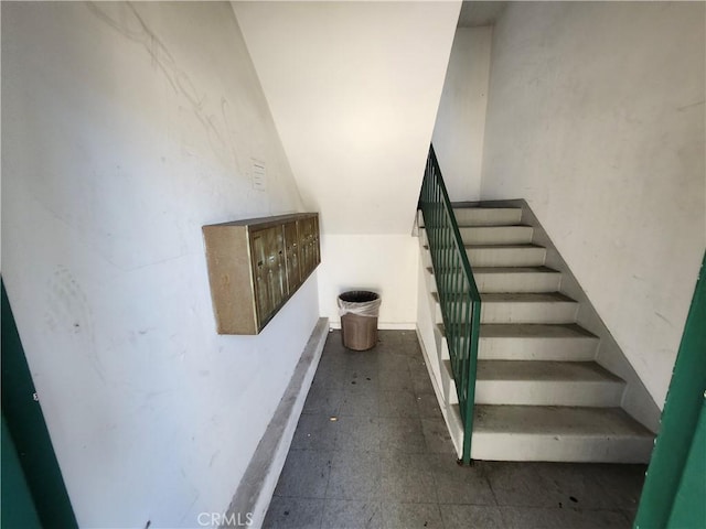 stairway featuring mail boxes