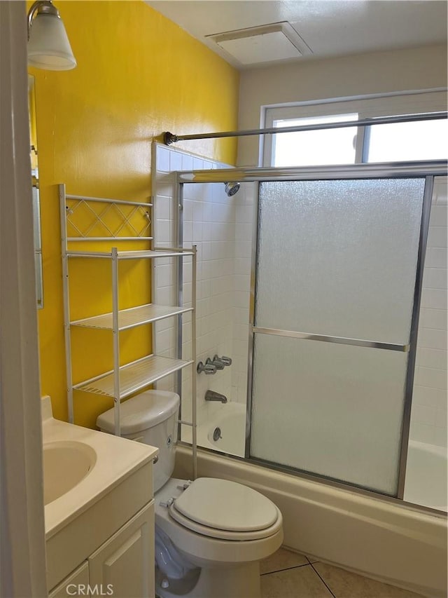 full bathroom featuring tile patterned flooring, vanity, toilet, and enclosed tub / shower combo