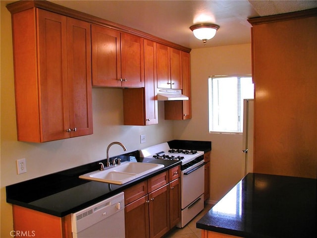 kitchen with white appliances, sink, and light tile patterned floors